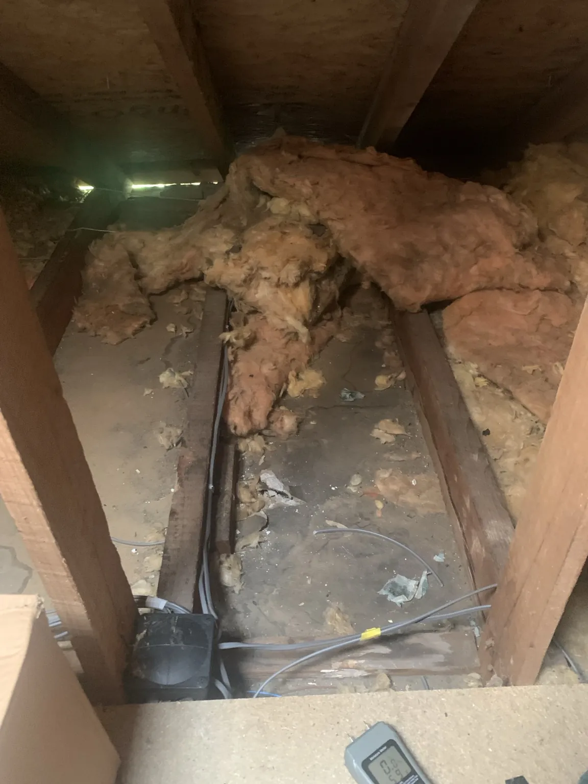 Displaced old insulation and exposed ceiling joists before loft restoration in Crossmyloof, Glasgow