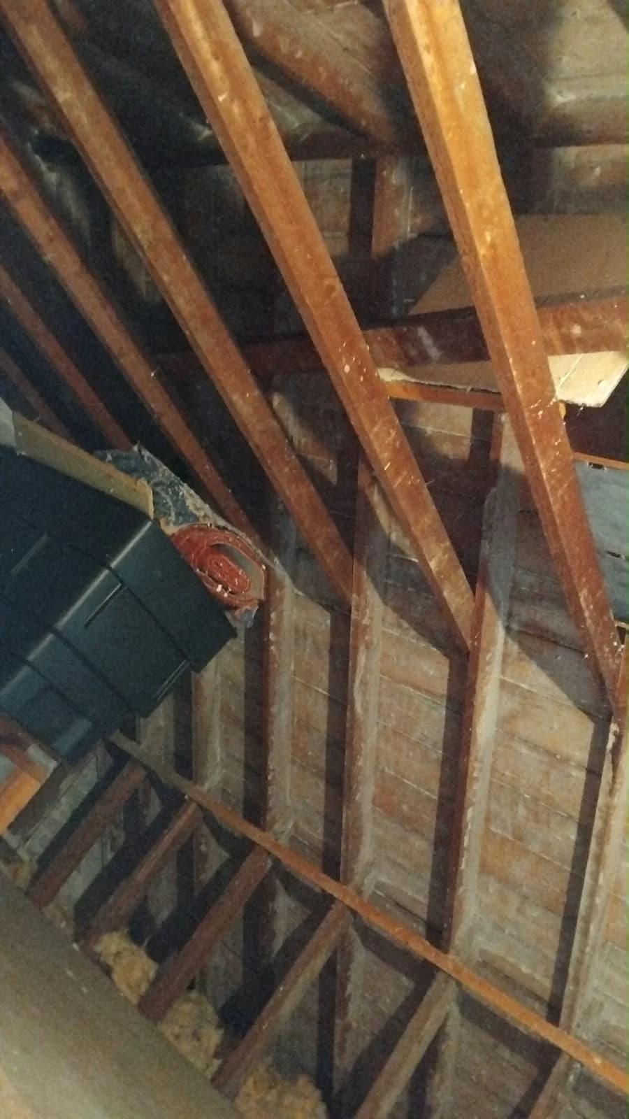 Exposed roof boards and timbers following spray foam removal in Dalry, North Ayrshire